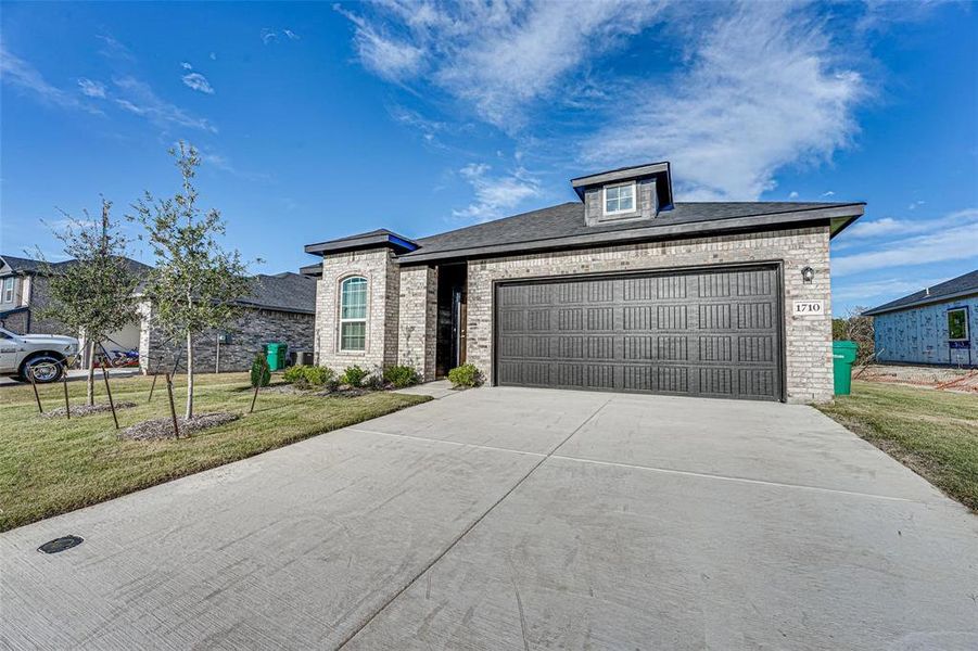 Front exterior of a new home in The Grove, Sherman, TX, highlighting curb appeal (Image 1). Front exterior of a new home in The Grove, Sherman, TX, highlighting curb appeal (Image 1).