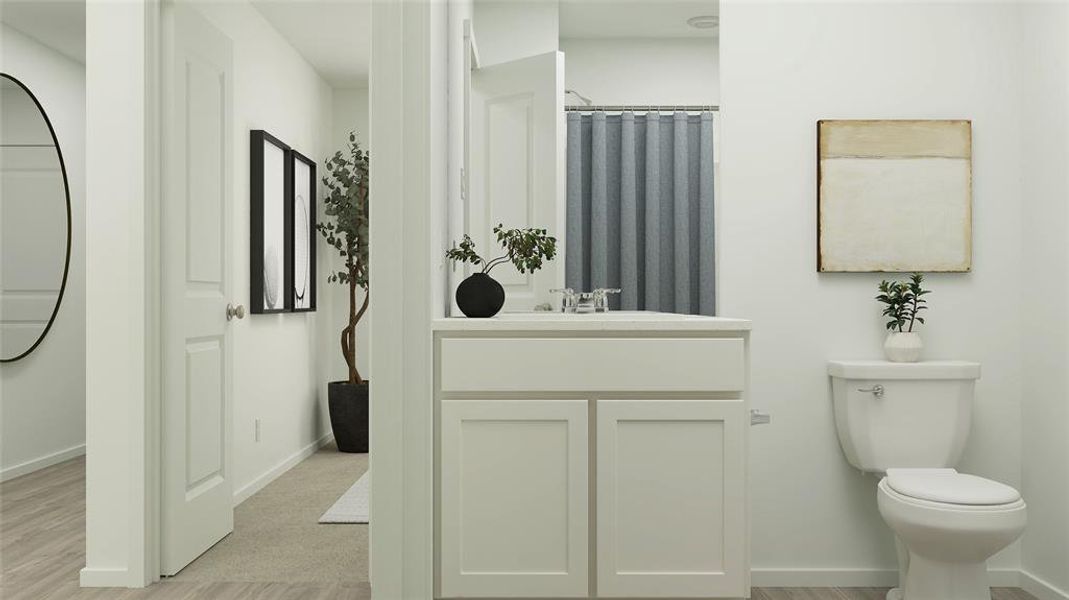 Bathroom featuring hardwood / wood-style flooring, vanity, and toilet