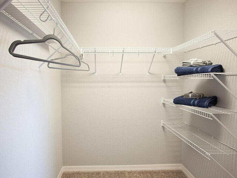 Built-in storage includes this walk-in wardrobe with linen stack in the owner`s suite - Parker ll home plan by Highland Homes