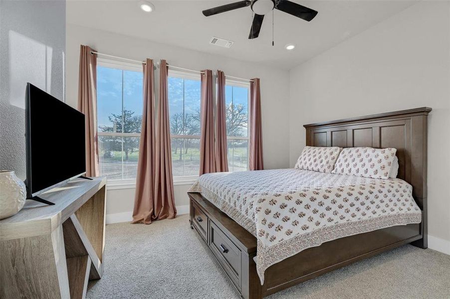 Bedroom featuring ceiling fan and light colored carpet