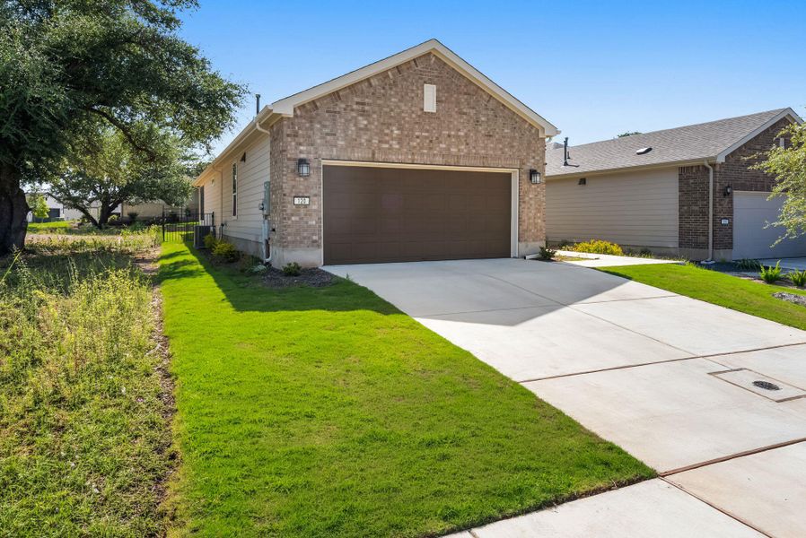 A well-maintained lawn and concrete driveway lead to this charming brick-front residence. A well-maintained lawn and concrete driveway lead to this charming brick-front residence.