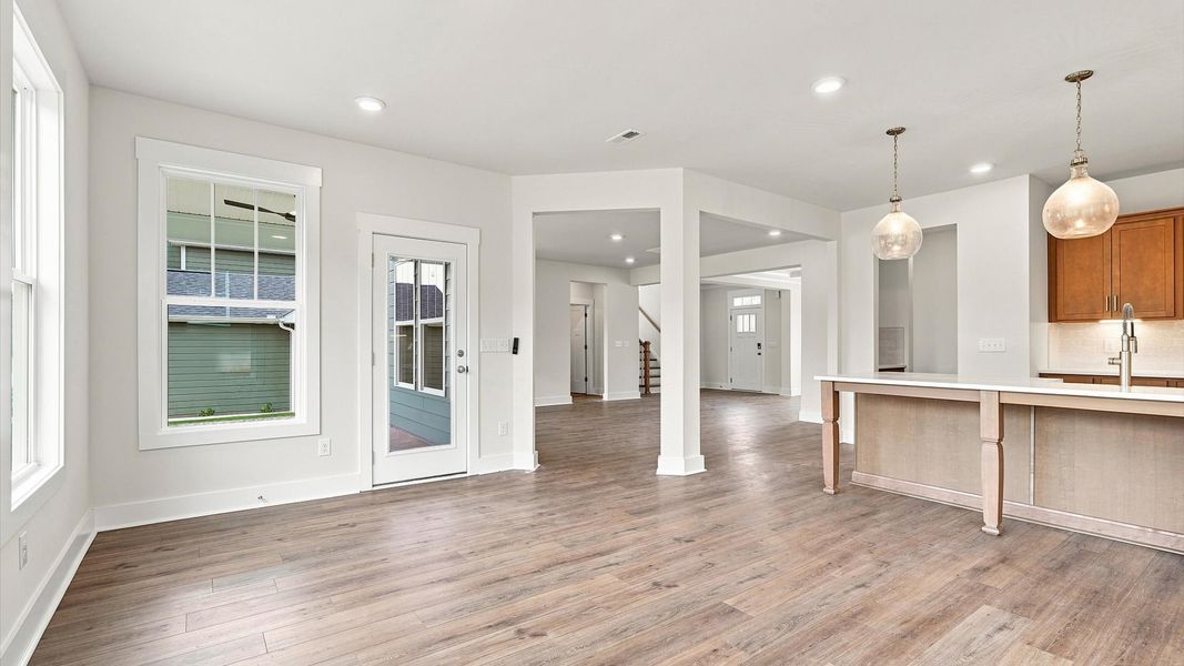 Spacious family room with rich hardwood flooring and elegant trim work in a reputable DRB Homes build