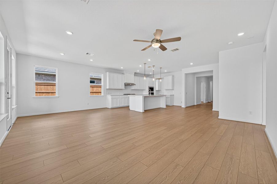 Beautiful wood-look flooring runs throughout the main living spaces, adding warmth and continuity to the open layout.