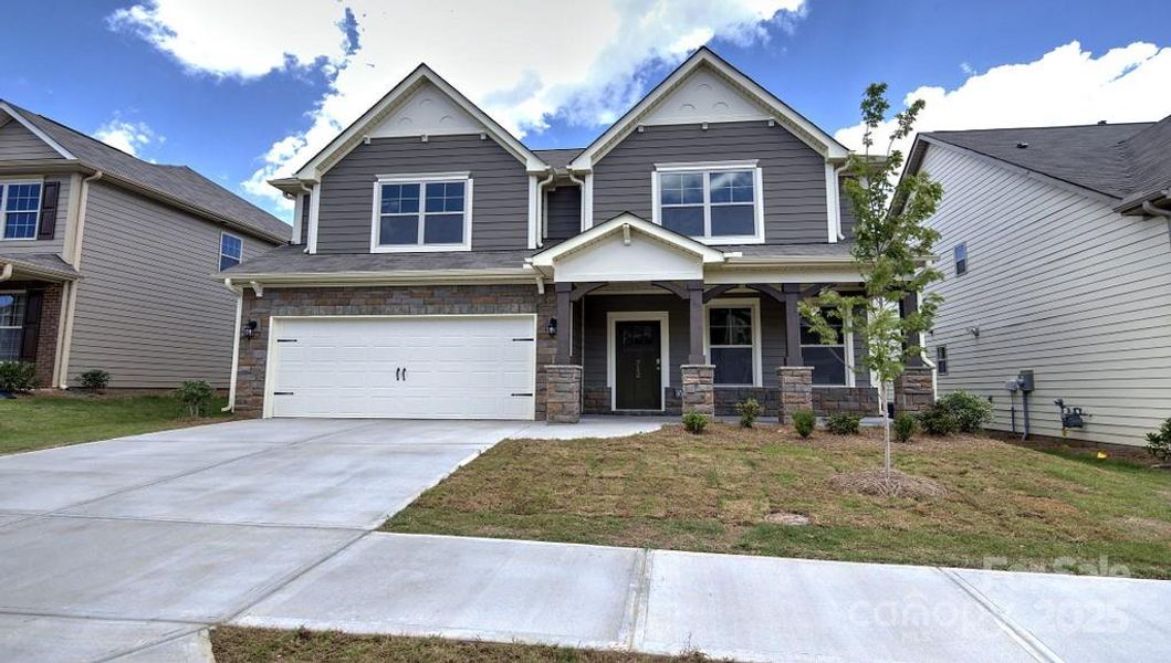 Front exterior of a new home in Falls Cove, Troutman, NC, highlighting curb appeal (Image 1).