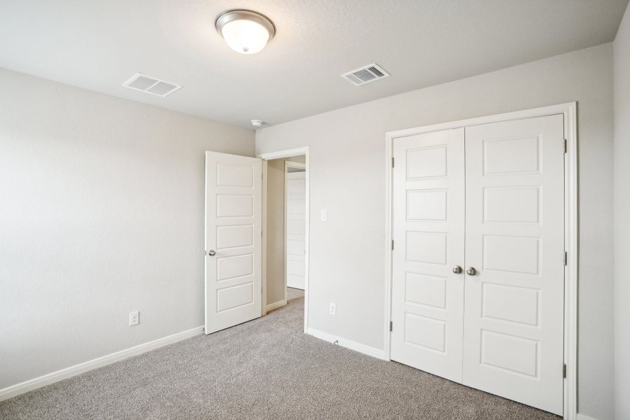 Guest bedroom of the Reynolds floorplan at a Meritage Homes community.