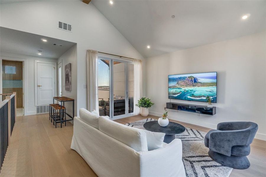 Plenty of Living area with light wood-style flooring, high vaulted ceiling, recessed lighting, and beamed ceiling