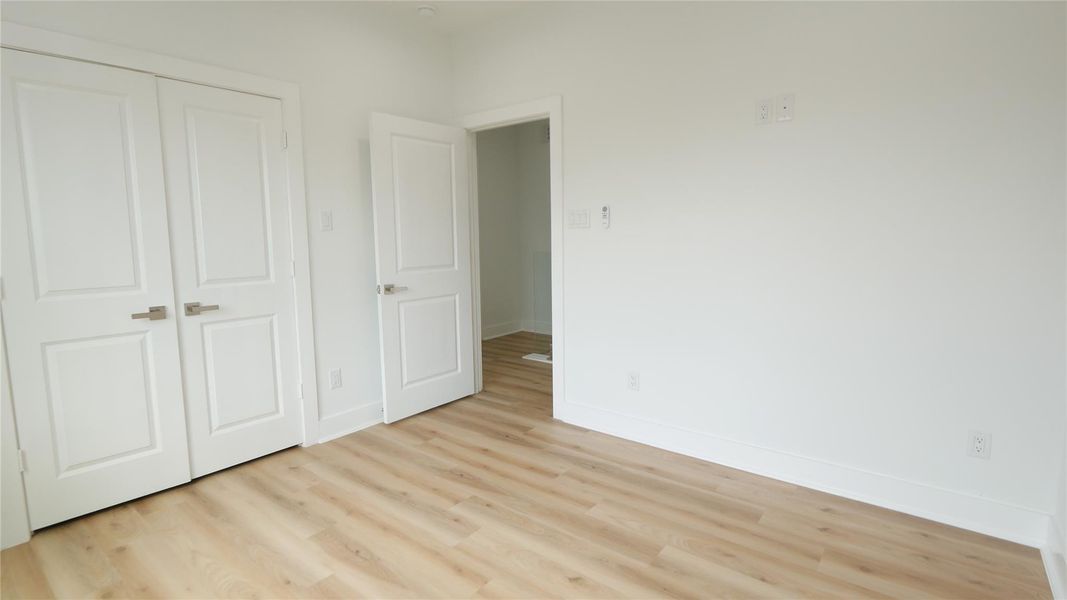 This room features light wood flooring and white walls, creating a bright and airy atmosphere. It has a double door leading to the Closet, offering versatility and storage options. This room features light wood flooring and white walls, creating a bright and airy atmosphere. It has a double door leading to the Closet, offering versatility and storage options.