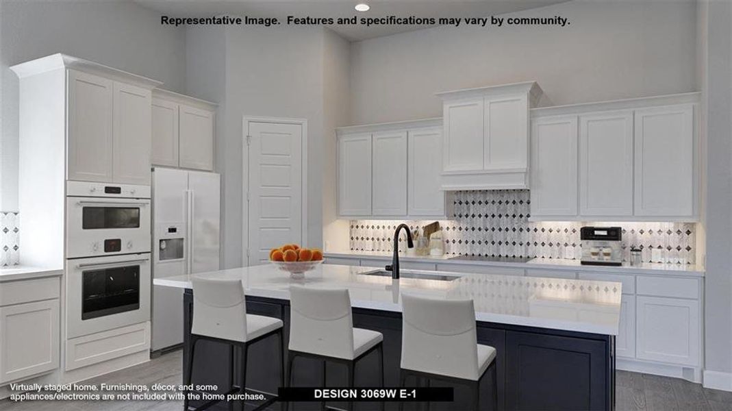 Kitchen featuring a towering ceiling, hardwood / wood-style flooring, an island with sink, white appliances, and sink