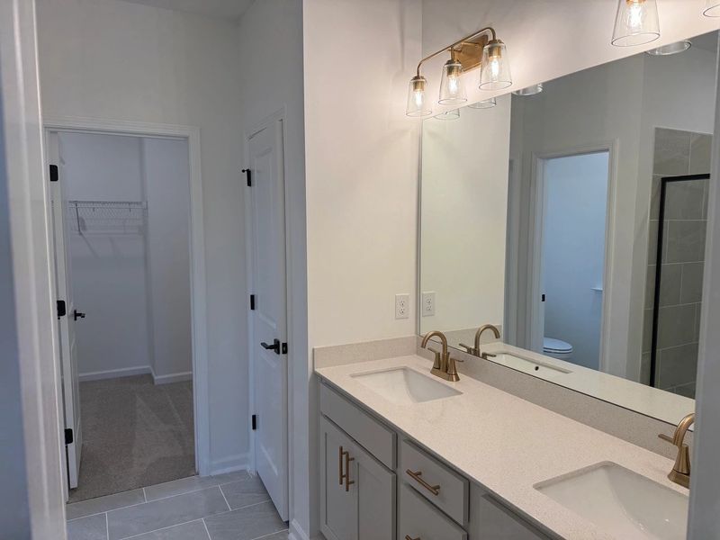 Primary Walk-In featuring the AW Collection® Serene - Open storage with understated design. Primary Walk-In featuring the AW Collection® Serene - Open storage with understated design.