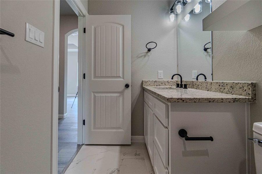 Bathroom featuring tile patterned flooring and vanity