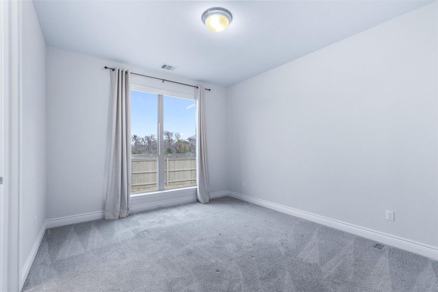Unfurnished room featuring carpet floors and baseboards