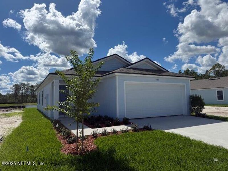 Front exterior of a new home in Grand Reserve, Bunnell, FL, highlighting curb appeal (Image 1).