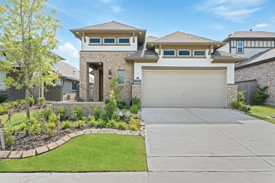 Front exterior of a new home in , Cypress, TX, highlighting curb appeal (Image 1).