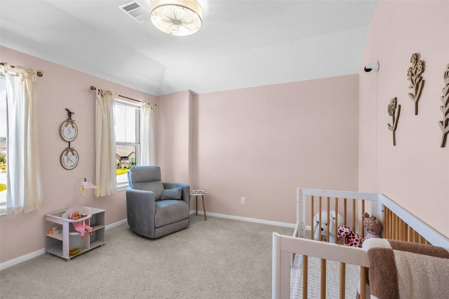 Located in the left corner of the second floor, this secondary bedroom overlooks the front of the home.