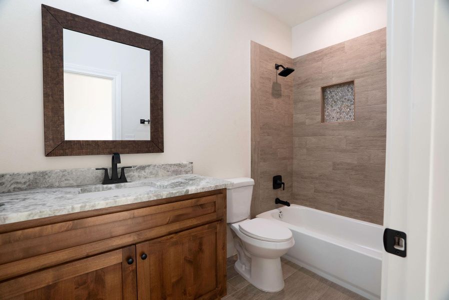 Bathroom with vanity and bathing tub / shower combination Bathroom with vanity and bathing tub / shower combination