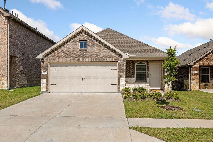 Brick and stone facade featuring a single-car garage with a concrete driveway Brick and stone facade featuring a single-car garage with a concrete driveway
