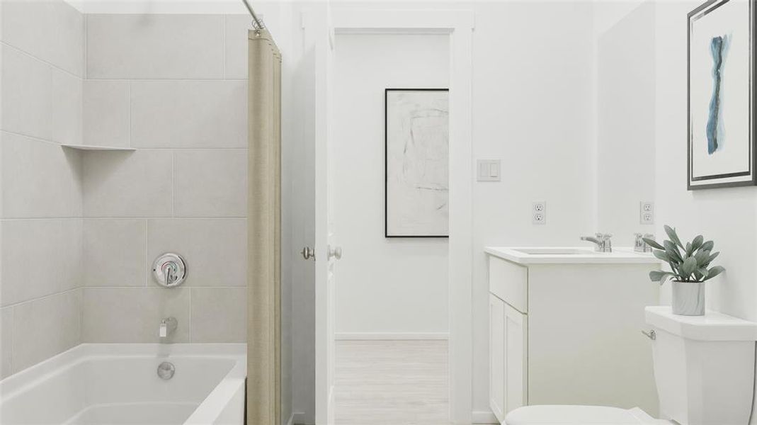 Full bath featuring vanity, shower / bath combo, and light wood-style flooring Full bath featuring vanity, shower / bath combo, and light wood-style flooring