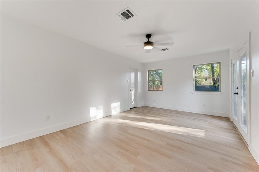 Spare room featuring light wood-type flooring and ceiling fan