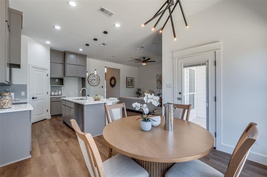 Dining area with ceiling fan, light hardwood / wood-style flooring, and sink