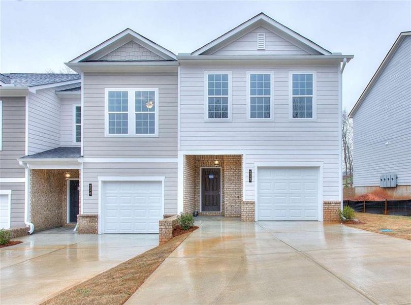 Front exterior of a new home in , South Fulton, GA, highlighting curb appeal (Image 1). Front exterior of a new home in , South Fulton, GA, highlighting curb appeal (Image 1).
