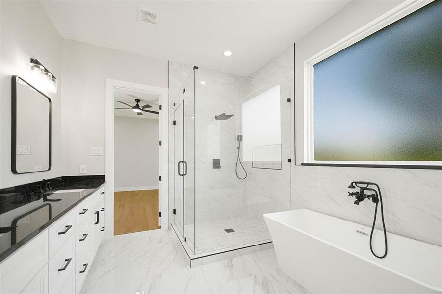 Bathroom with a marble finish shower, a freestanding bath, ceiling fan, vanity, and recessed lighting Bathroom with a marble finish shower, a freestanding bath, ceiling fan, vanity, and recessed lighting