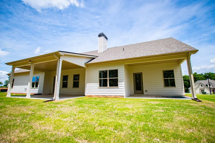 Exterior details and patio area of a home in WOODMONT RESERVE, Roopville (Image 32).