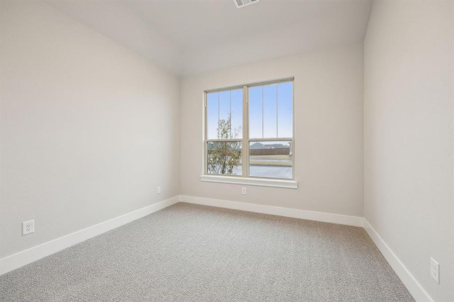 Empty room with a water view and carpet flooring