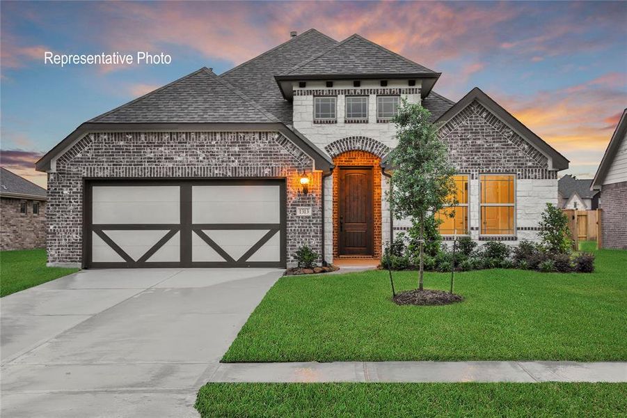 French country home with a garage and a lawn