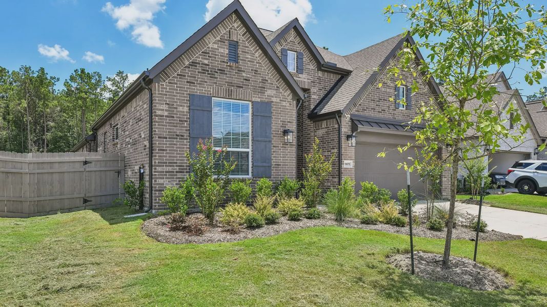 Front exterior of a new home in Artavia, Conroe, TX, highlighting curb appeal (Image 22).