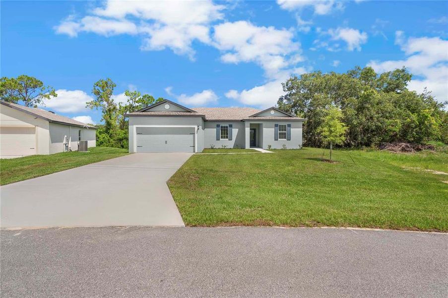 Front exterior of a new home in , Poinciana, FL, highlighting curb appeal (Image 15). Front exterior of a new home in , Poinciana, FL, highlighting curb appeal (Image 15).