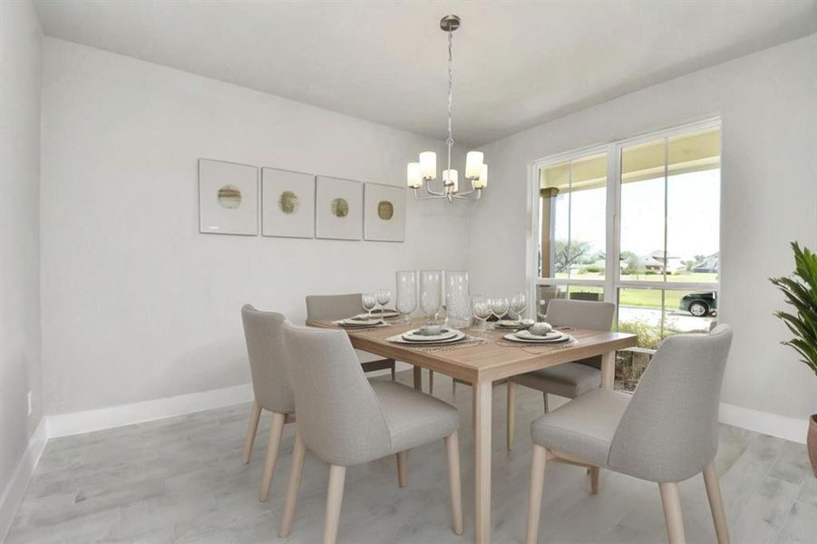 An inviting dining space. Revel in the stunning floors, soothing paint palette, and the crowning touch of a sleek chandelier – a perfect setting for shared meals and cherished moments. *Virtually Staged*