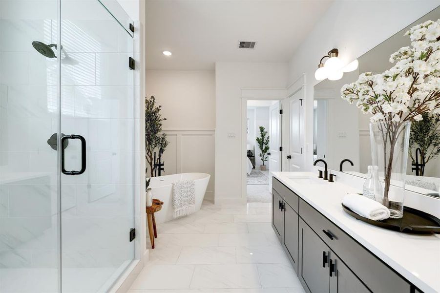 Ensuite Oasis: Featuring a spacious walk-in shower, luxurious soaking tub, and a dual-sink vanity set against elegant white tilework for a serene start to your day.