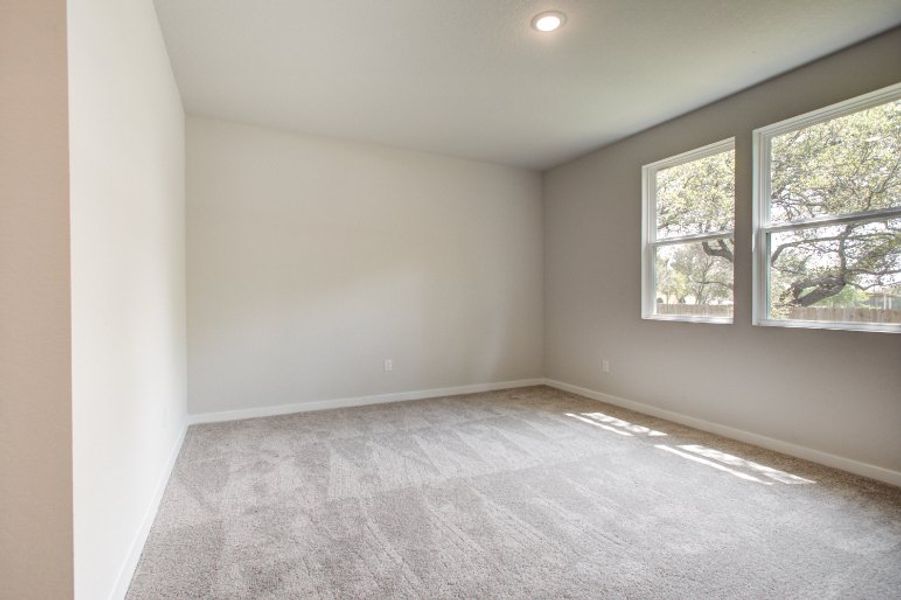 A room with a window and a carpet. A room with a window and a carpet.