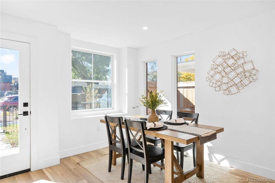 Abundant natural light fills this inviting dining area, creating a warm and welcoming atmosphere.