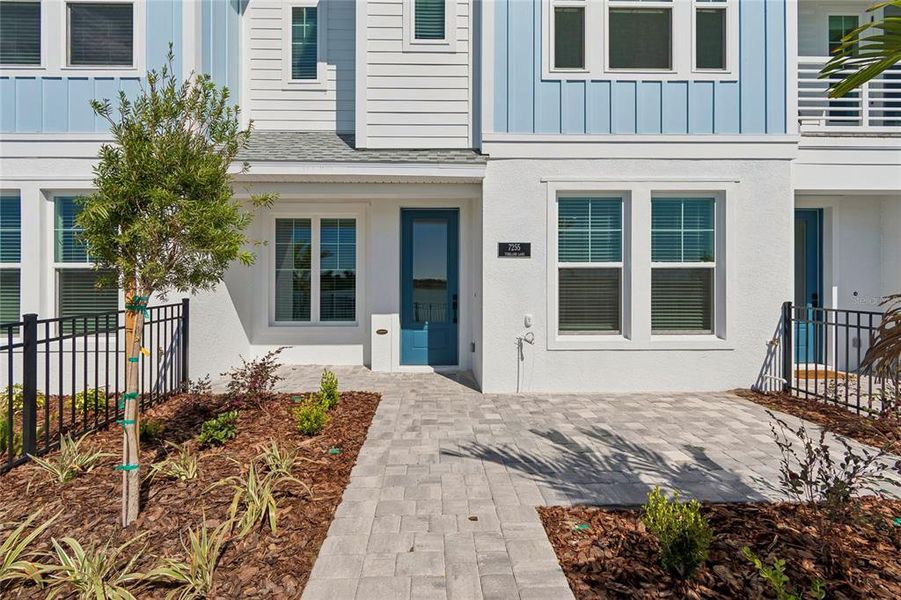 Exterior details and patio area of a home in Emerald Landing at Waterside at Lakewood Ranch – Towns, Sarasota (Image 3).