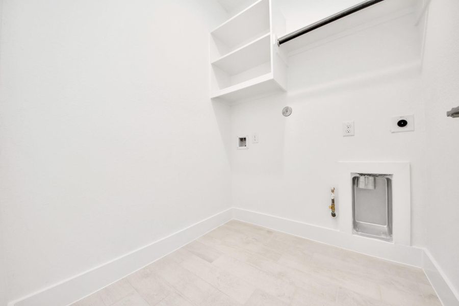 A perfect blend of functionality and comfort. Capture the essence of easy living with a first-floor laundry room, thoughtfully equipped with shelving for effortless organization. Both electric and gas connections available. A perfect blend of functionality and comfort. Capture the essence of easy living with a first-floor laundry room, thoughtfully equipped with shelving for effortless organization. Both electric and gas connections available.