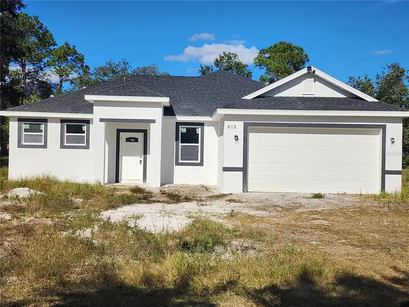 Front exterior of a new home in , Palm Bay, FL, highlighting curb appeal (Image 1).
