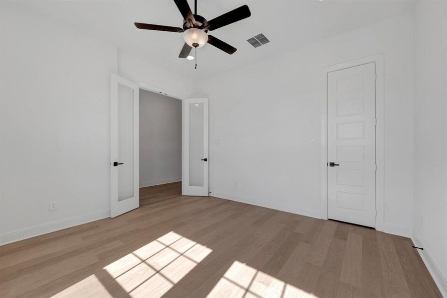 Unfurnished bedroom with light wood-type flooring and a ceiling fan