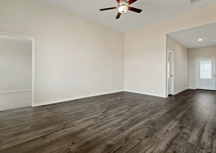 Vinyl flooring is found throughout the family room