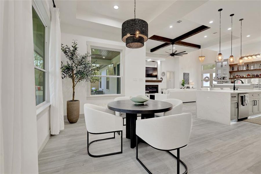 Dining area with gorgeous lighting fixture provides a back yard peaceful view. Very private!