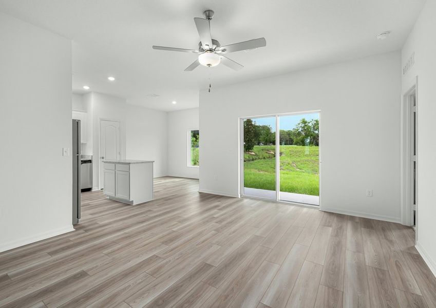 Sliding doors in the family room lead to the back yard