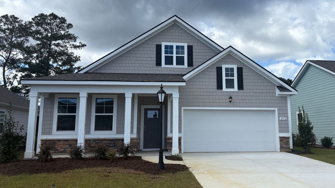 Front exterior of a new home in Rich Square at Brunswick Plantation, Ash, NC, highlighting curb appeal (Image 1).