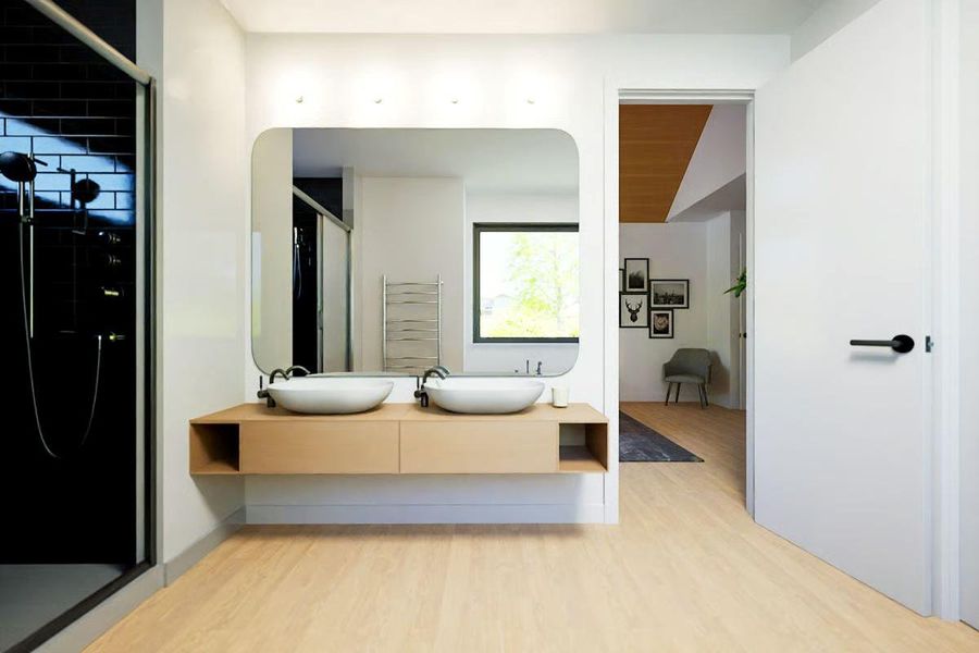 Modern ensuite bath featuring a floating dual-sink vanity and walk-in shower. Modern ensuite bath featuring a floating dual-sink vanity and walk-in shower.