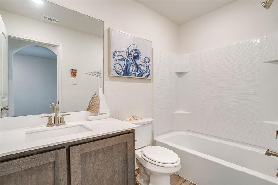 Full bath featuring vanity and shower / bath combination