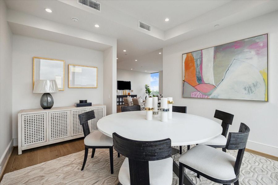 Spacious dining area features an open-concept layout seamlessly connected to the kitchen and living spaces. Photos are of a similar unit with the same floor plan