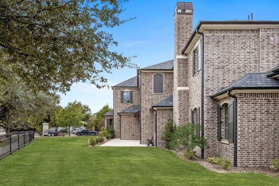 Back of house with a yard and a patio area