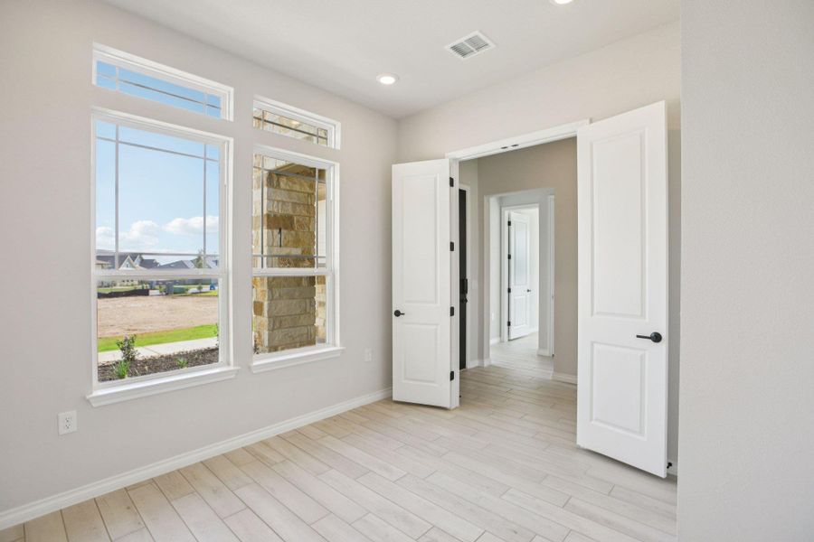 Spare room with light wood-style floors and recessed lighting