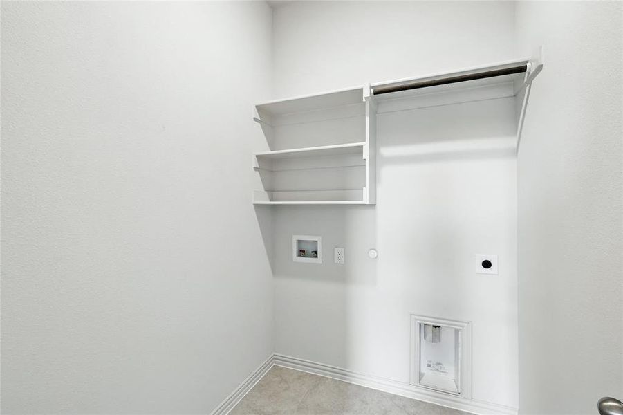 Laundry area featuring hookup for a gas dryer, hookup for a washing machine, electric dryer hookup, and light tile patterned flooring Laundry area featuring hookup for a gas dryer, hookup for a washing machine, electric dryer hookup, and light tile patterned flooring
