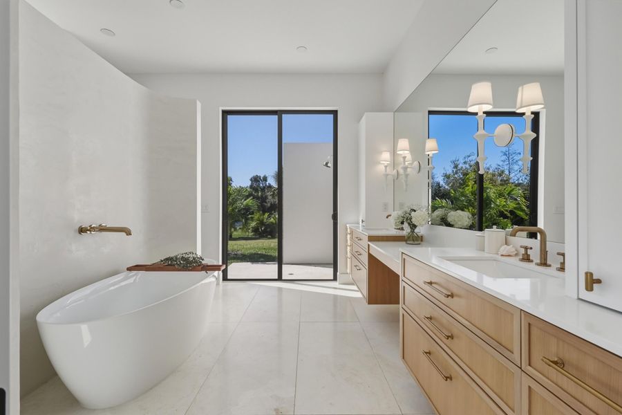 Owner's spa bathroom with arched plaster accent wall separating the walk-in shower & toilet area