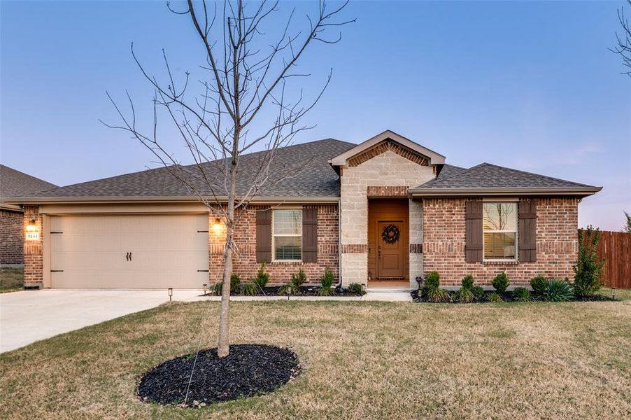 View of front of house featuring brick siding, concrete driveway, an attached garage, and a shingled roof
